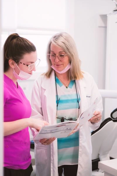 Dr. Fitzpatrick and dental assistant reviewing patient chart